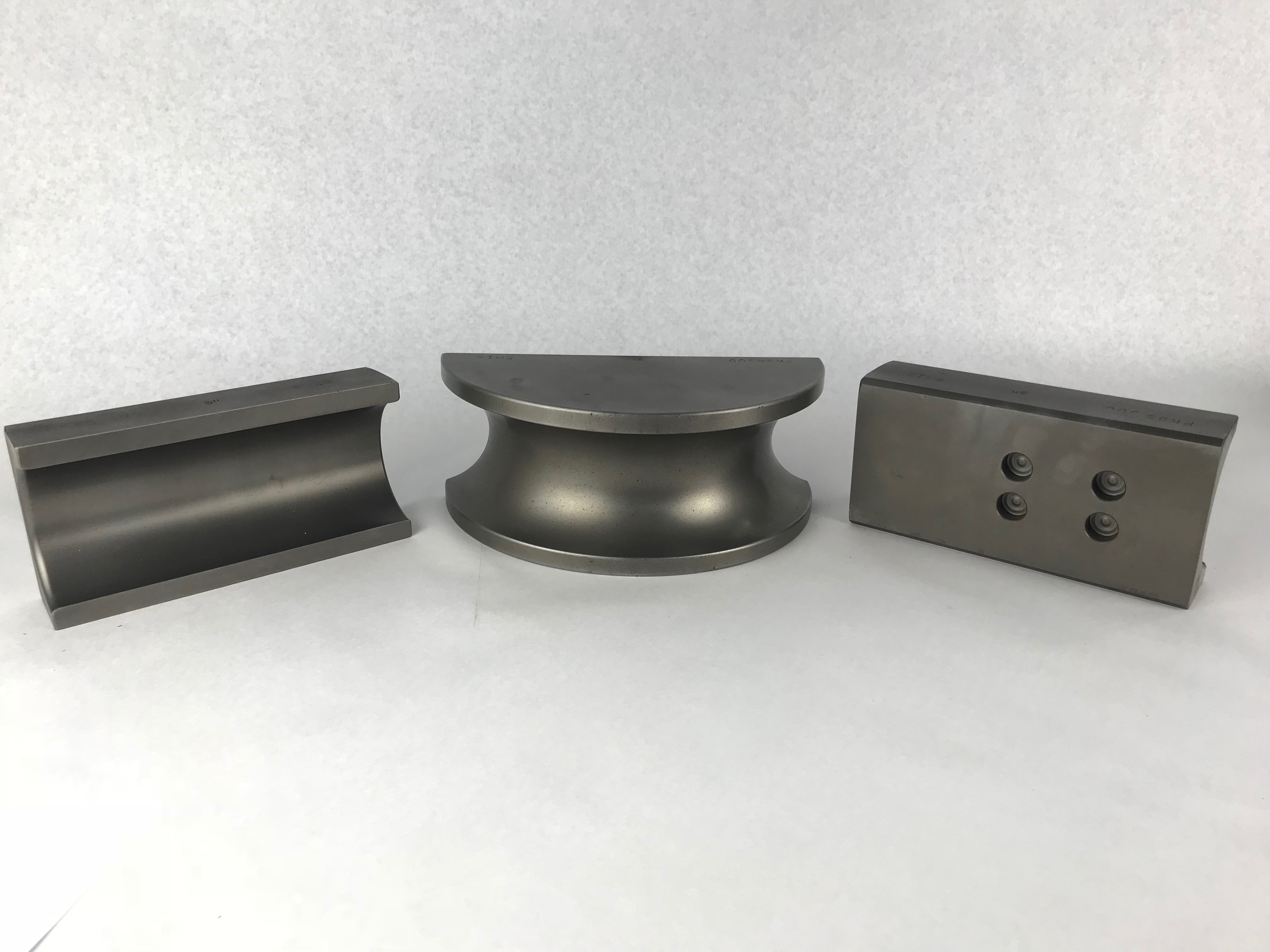 Steel Huth tooling pieces for BendPak®️ machines against a white background. Three parts are shown that are used as the back shoes and bending dies for 3