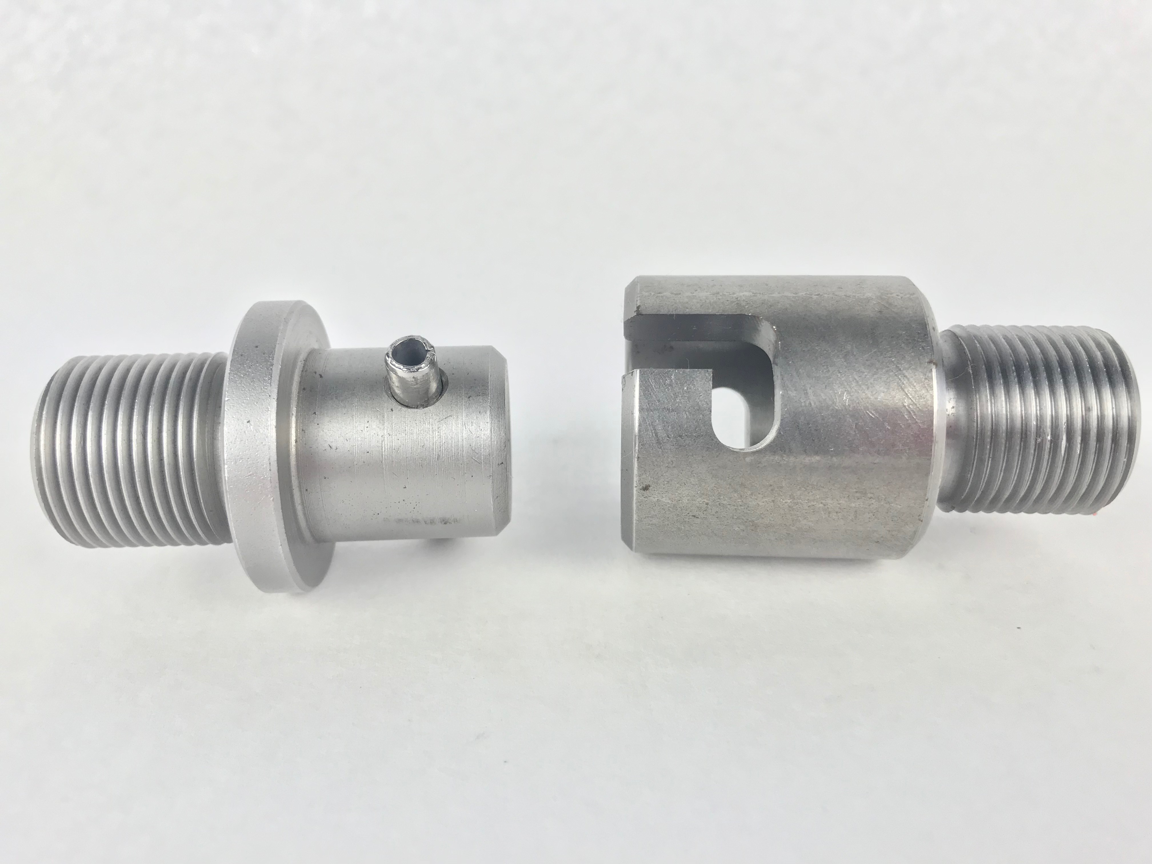 The Huth Swage PKDS-823 and PKDF-818 adapters allow you to connect your BendPak®️ machines to the Huth Swage end-forming tooling. The parts are shown on a white background. They are silver-colored and round. 