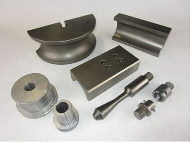 A collection of Huth-made tooling for BendPak® bending machines. The components are on a white background in shades of silver-colored steel. 